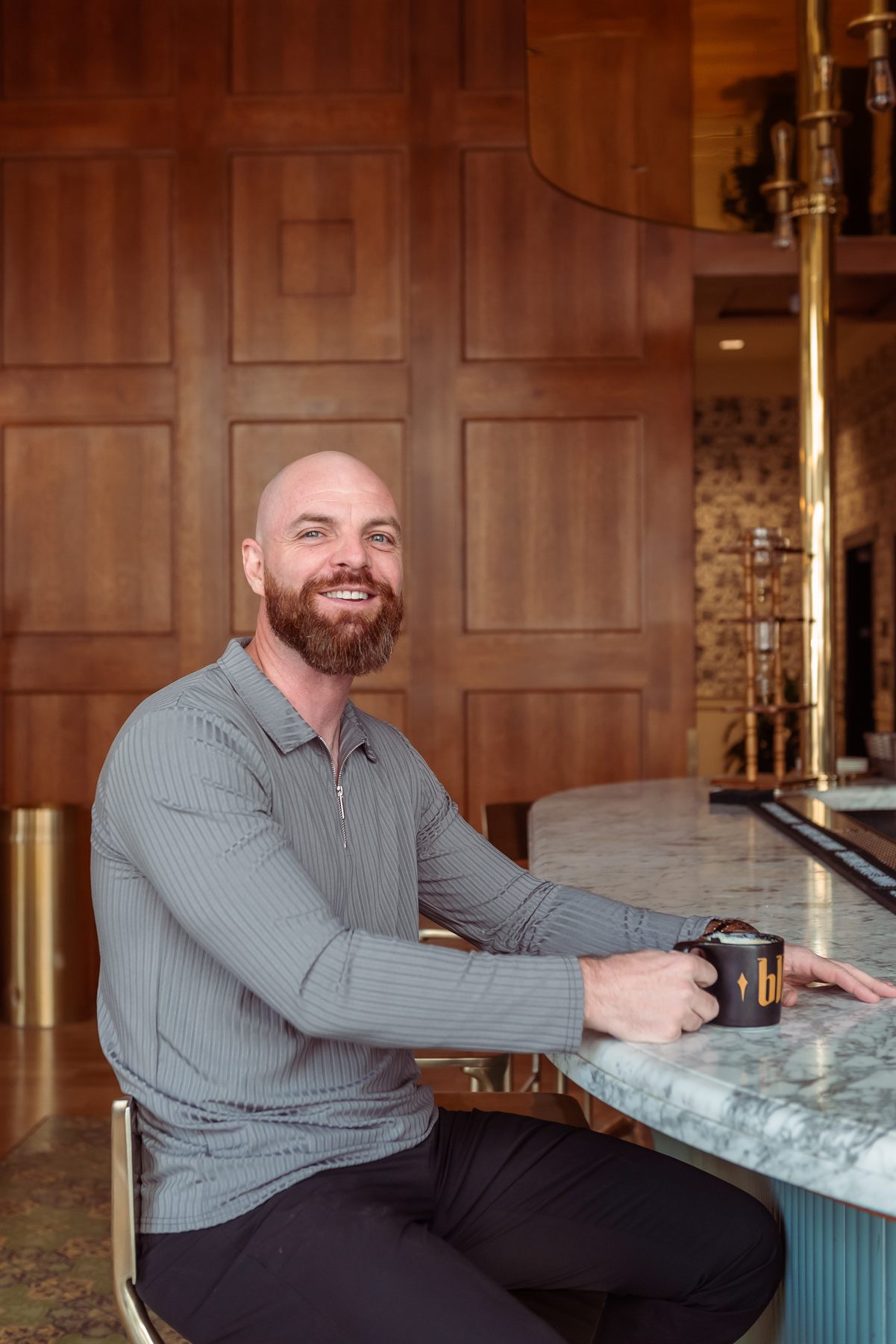 Jeremy seated at a marble counter, smiling.
