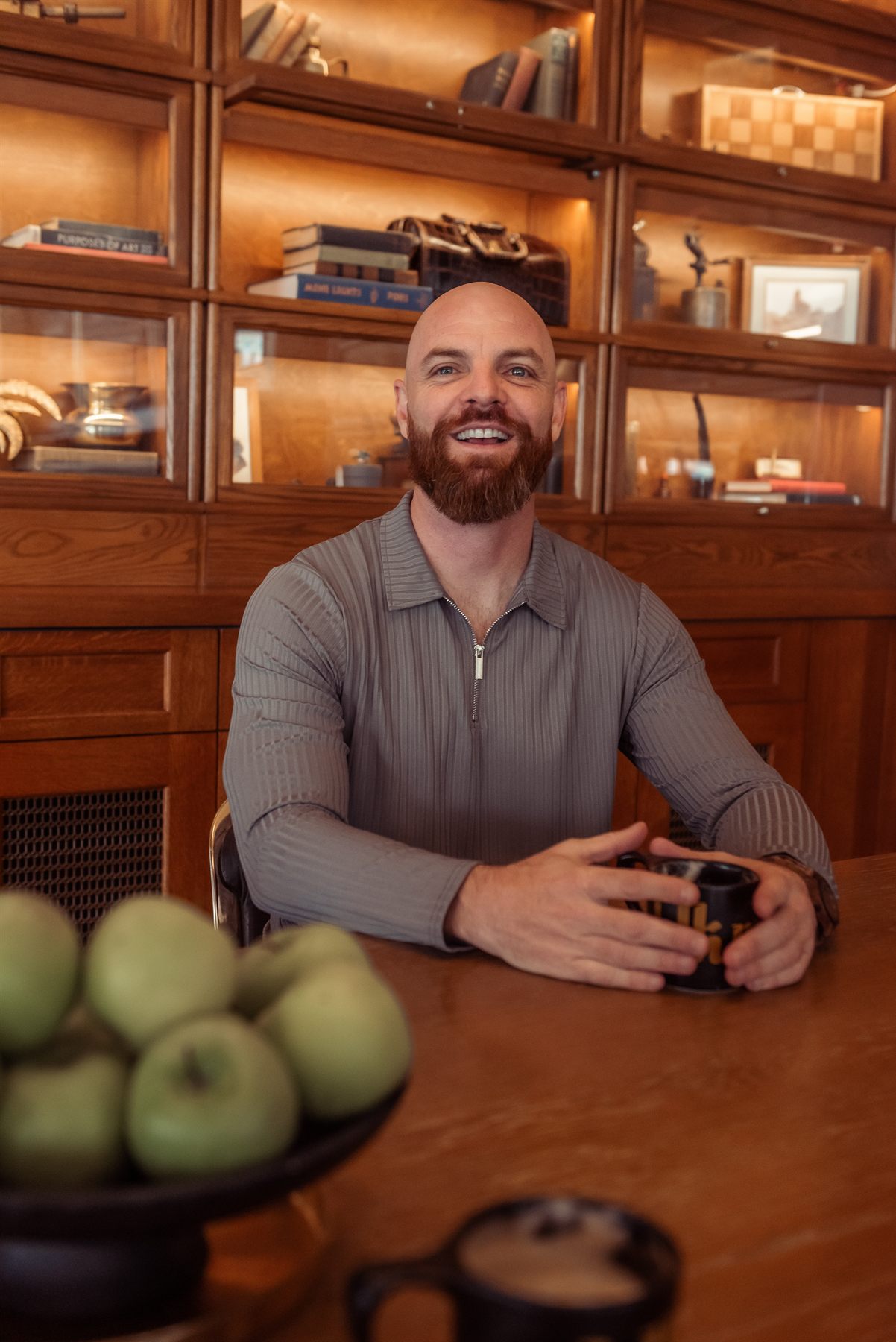Jeremy at a wood table, facing the camera.